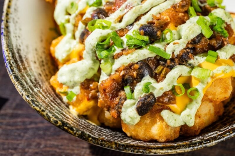 Haunting Jalapeño Tots
Icon Tots topped with plant-based black bean chili, cheddar sauce, and jalapeño sauce
